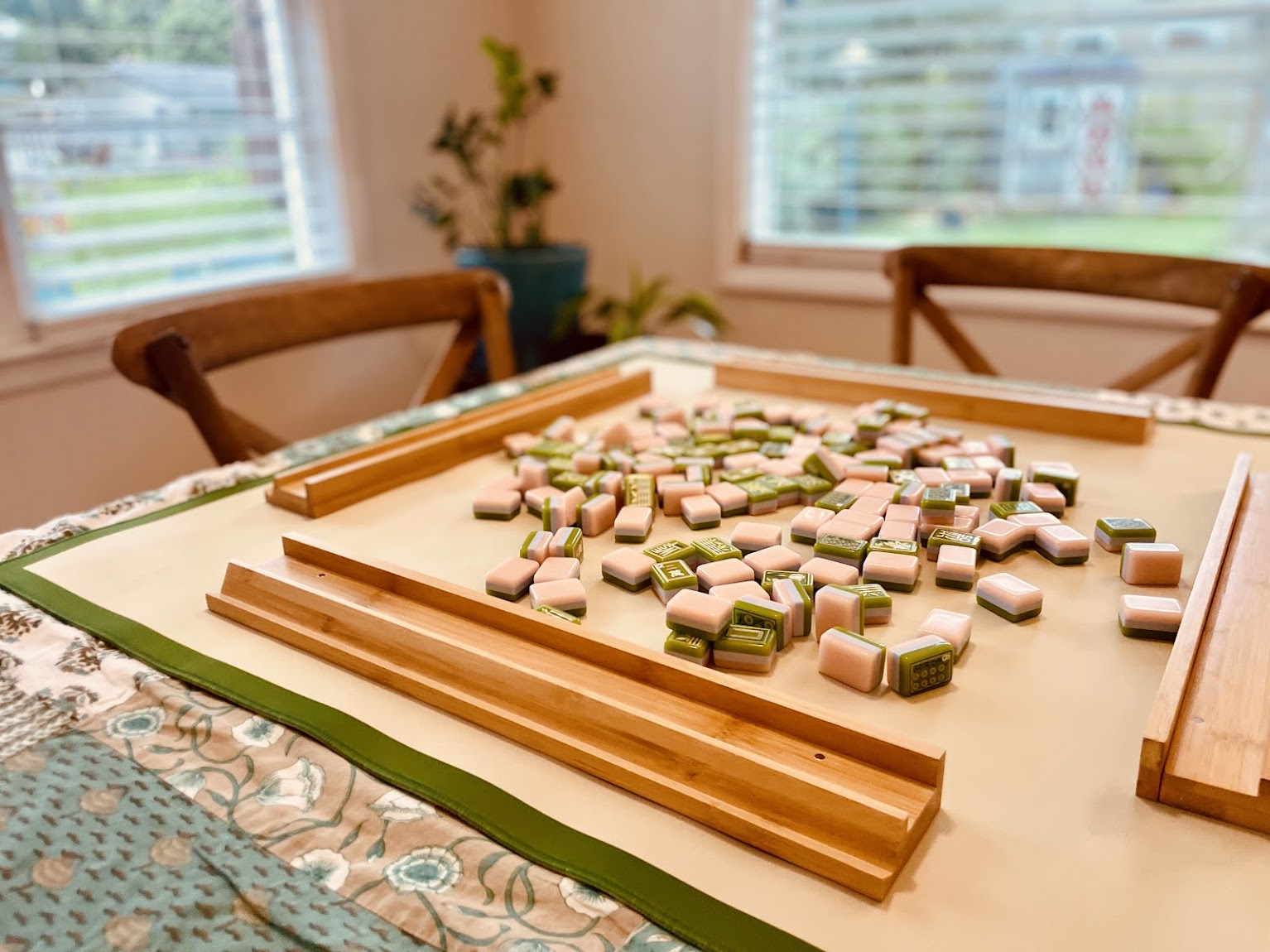 Mahjong tiles ready for play around a table