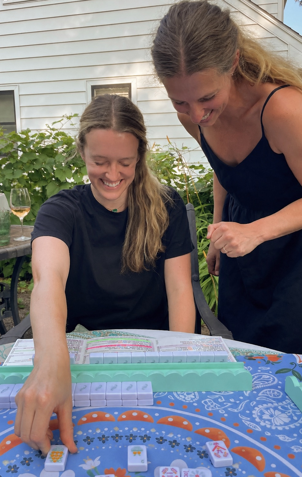 Annie smiling with a student during a mahjong lesson